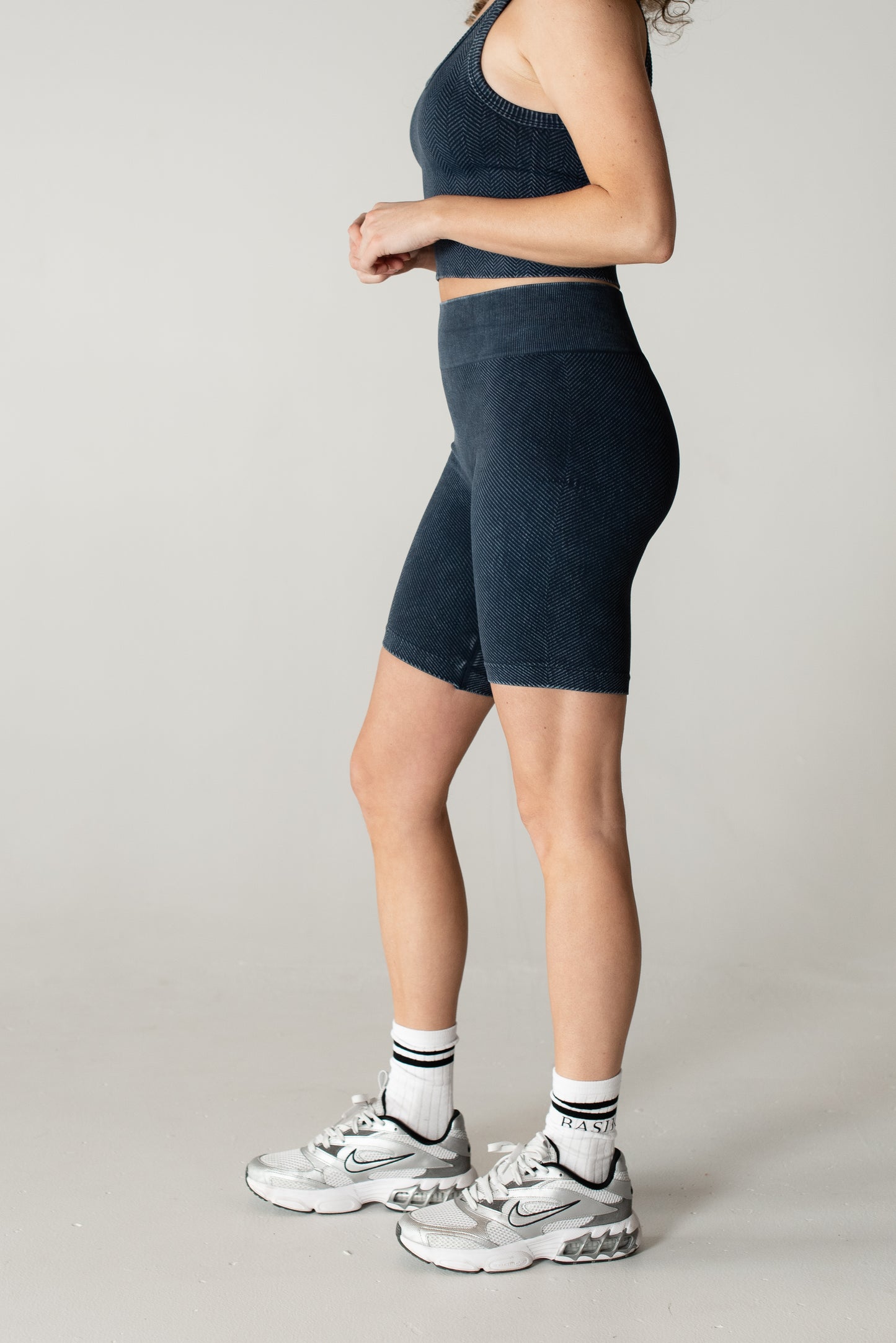 woman wearing high-waisted compression denim bottoms

side view of BASIK Nix shapewear jeans

close-up of tummy control waistband on Nix Bottoms
